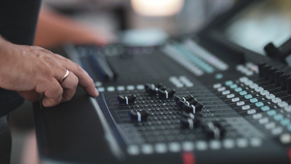 Hand on a digital mixing console