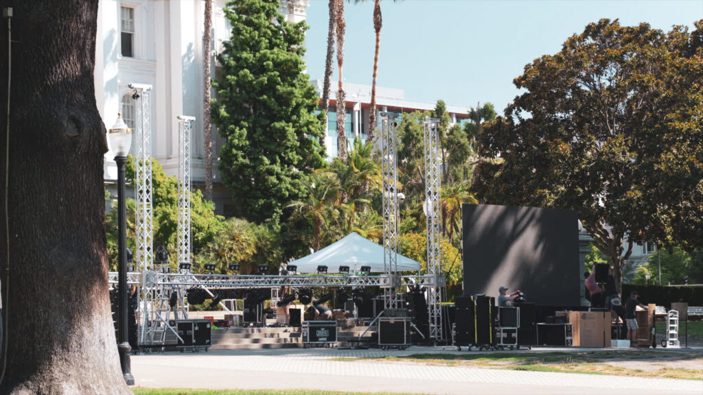 Outdoor stage build with truss and speaker towers